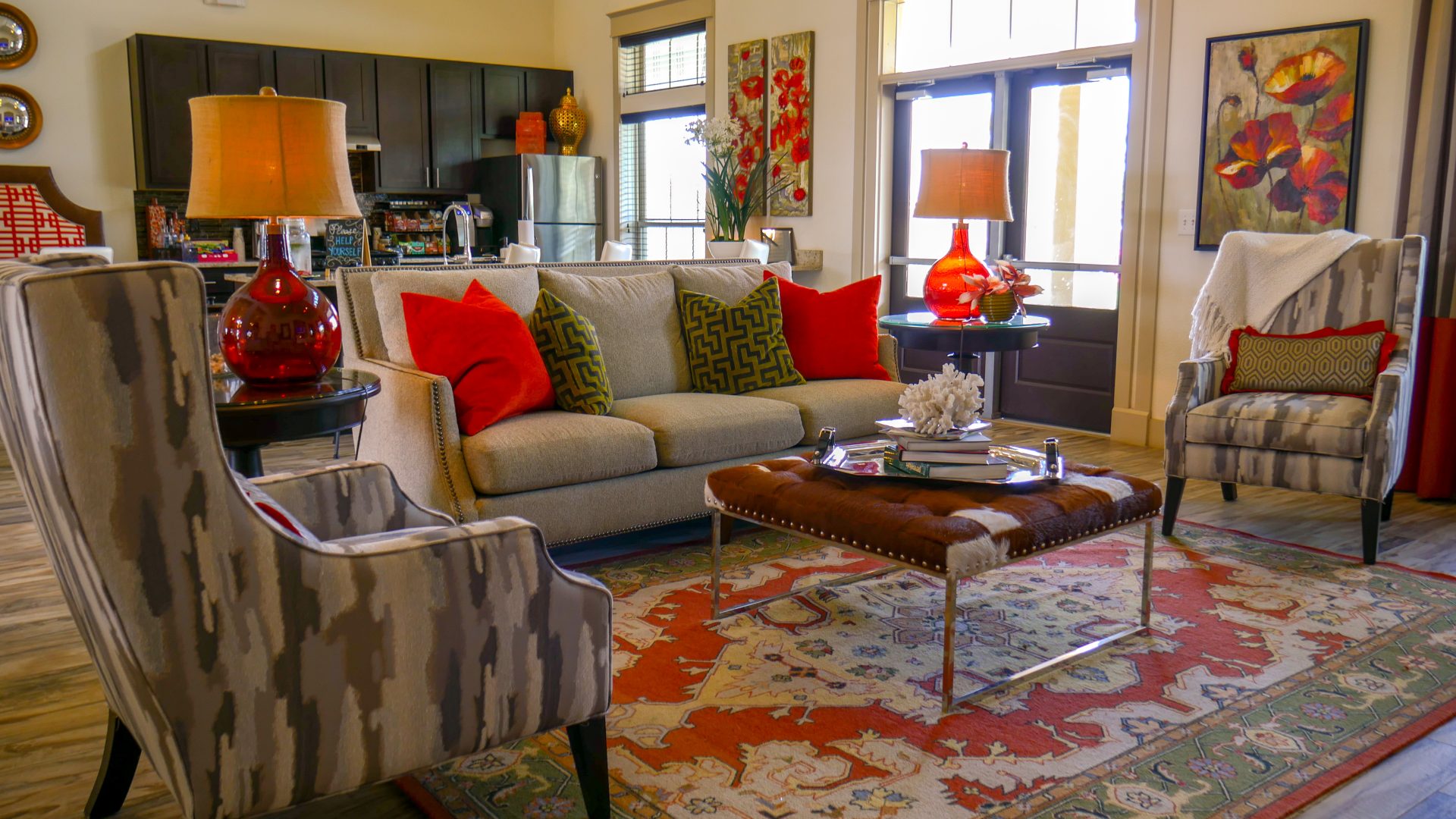 a living room with a red rug and a red couch at The Anatole on MacArthur North