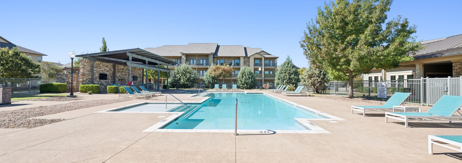 a pool with a lot of tables and chairs around it